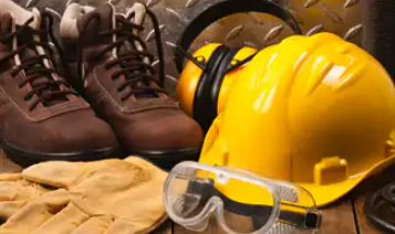 Tools of a construction worker (helmet, goggles and construction boots)